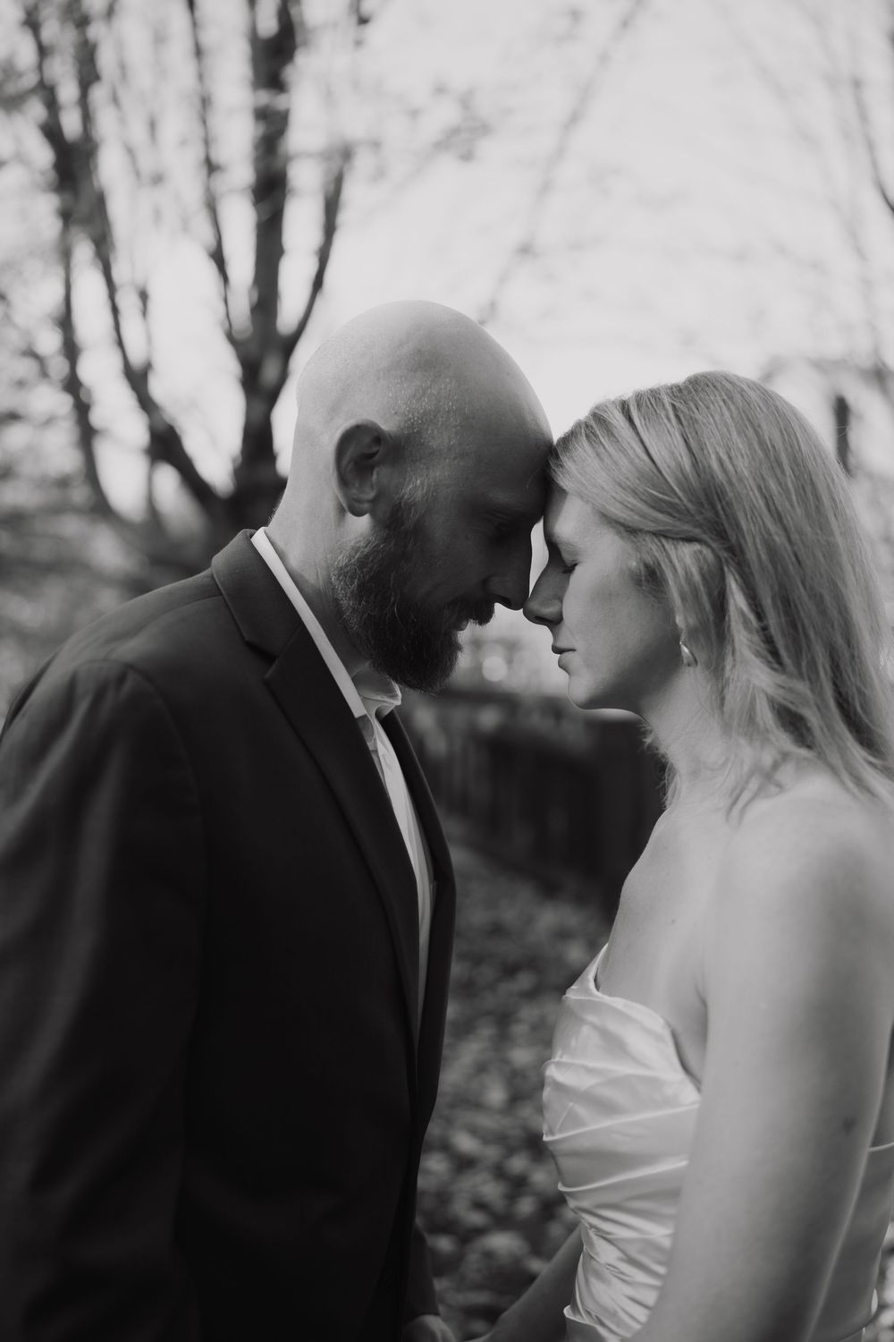 A romantic black and white sequence showing a couple in wedding attire sharing intimate moments in a wooded setting.