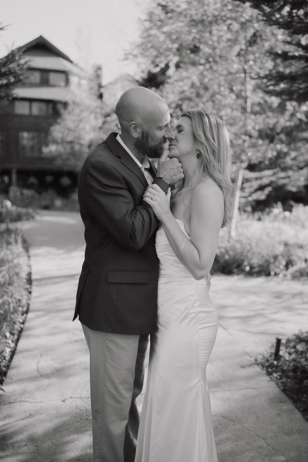 A romantic black and white photo sequence showing a couple sharing tender moments in an outdoor garden setting.