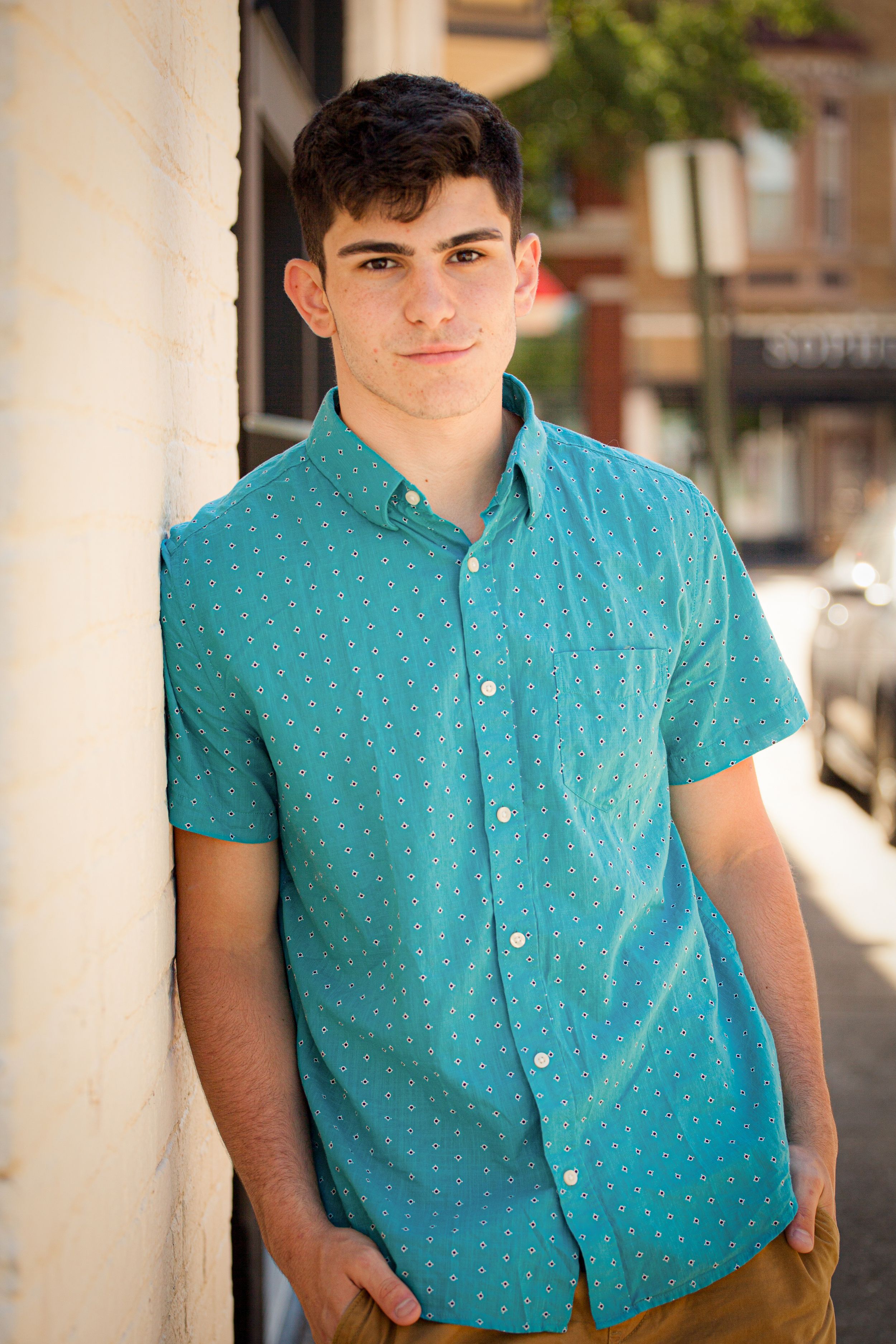 A collection of close-up shots featuring a turquoise polka dot shirt against a light architectural backdrop.