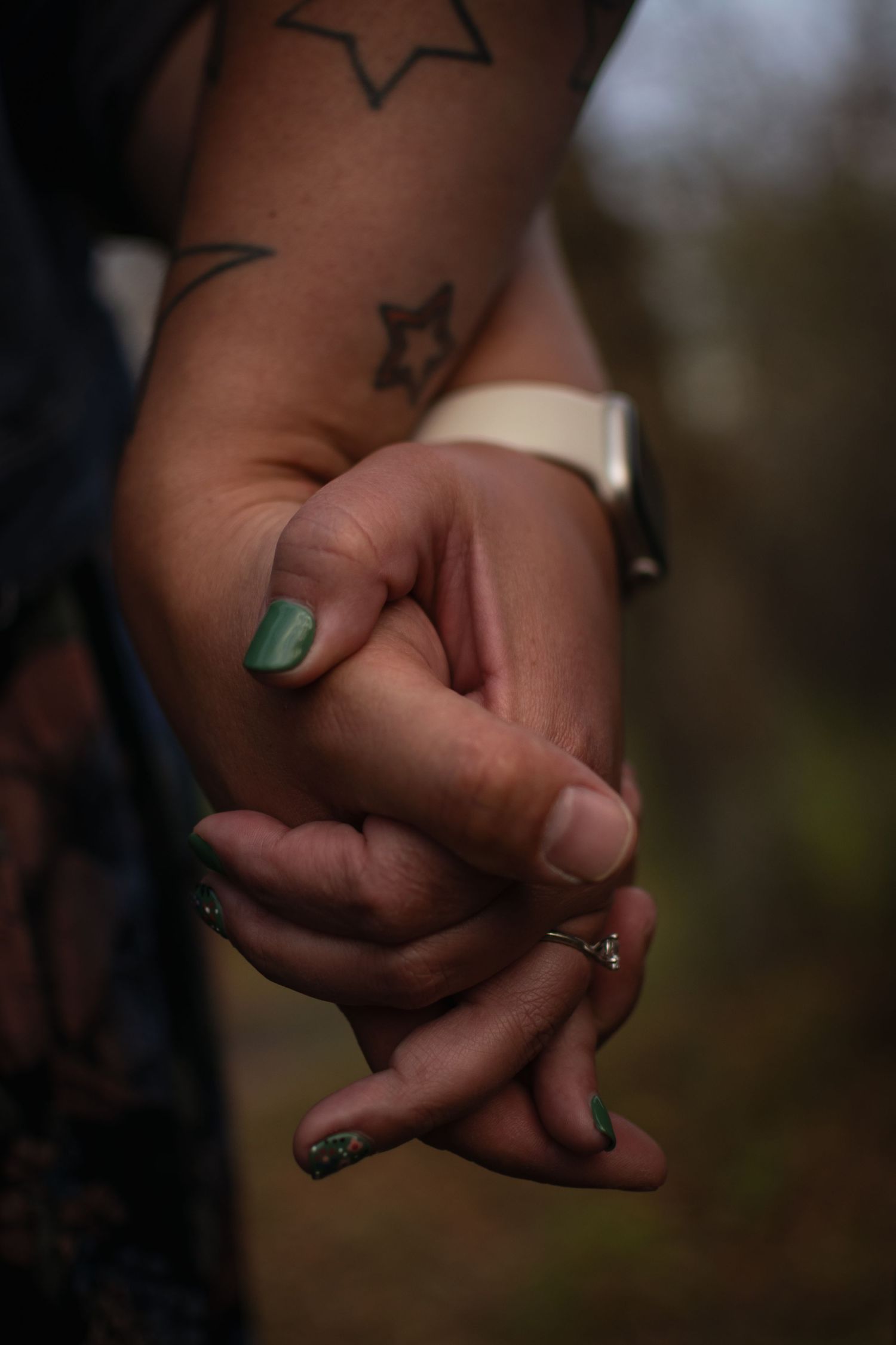 Close-up photo series showing two hands clasped together with green nail polish, symbolizing unity and connection.