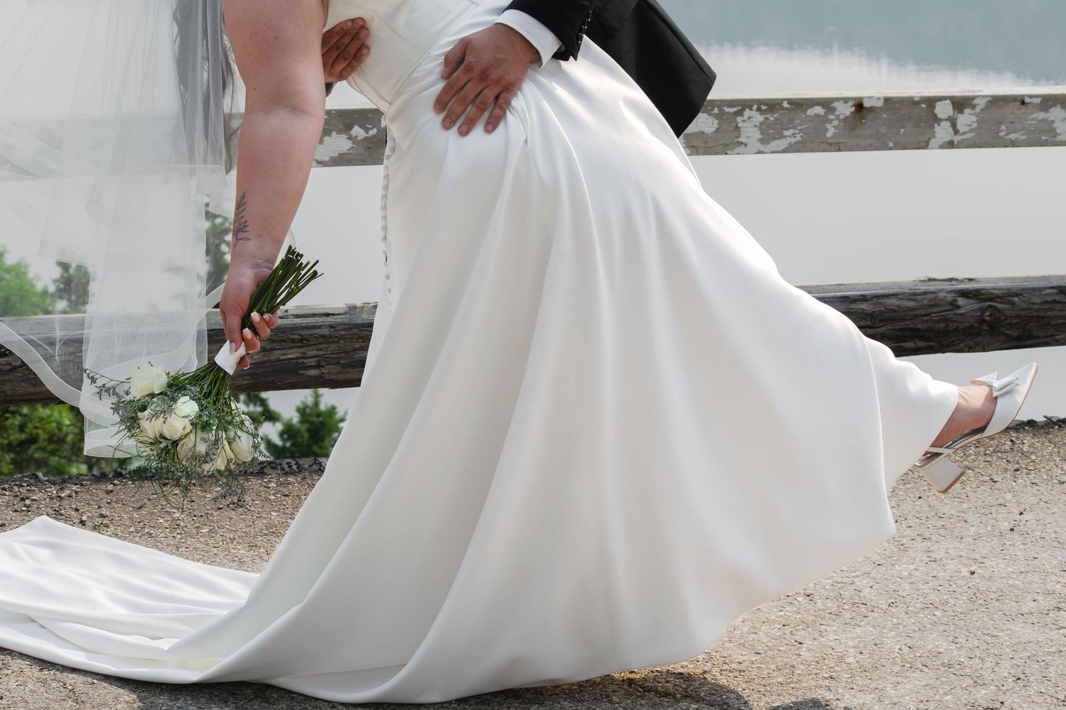 Close-up details of white wedding dress hemlines with delicate lace trim.