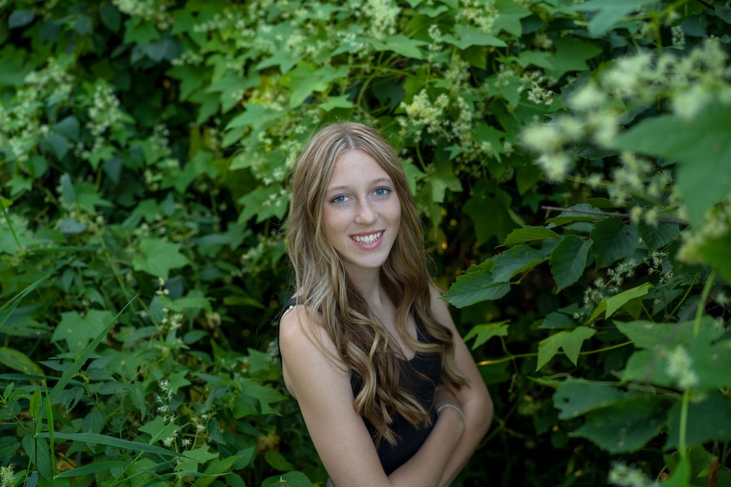 A series of outdoor portrait shots among lush green foliage and trees in natural lighting.