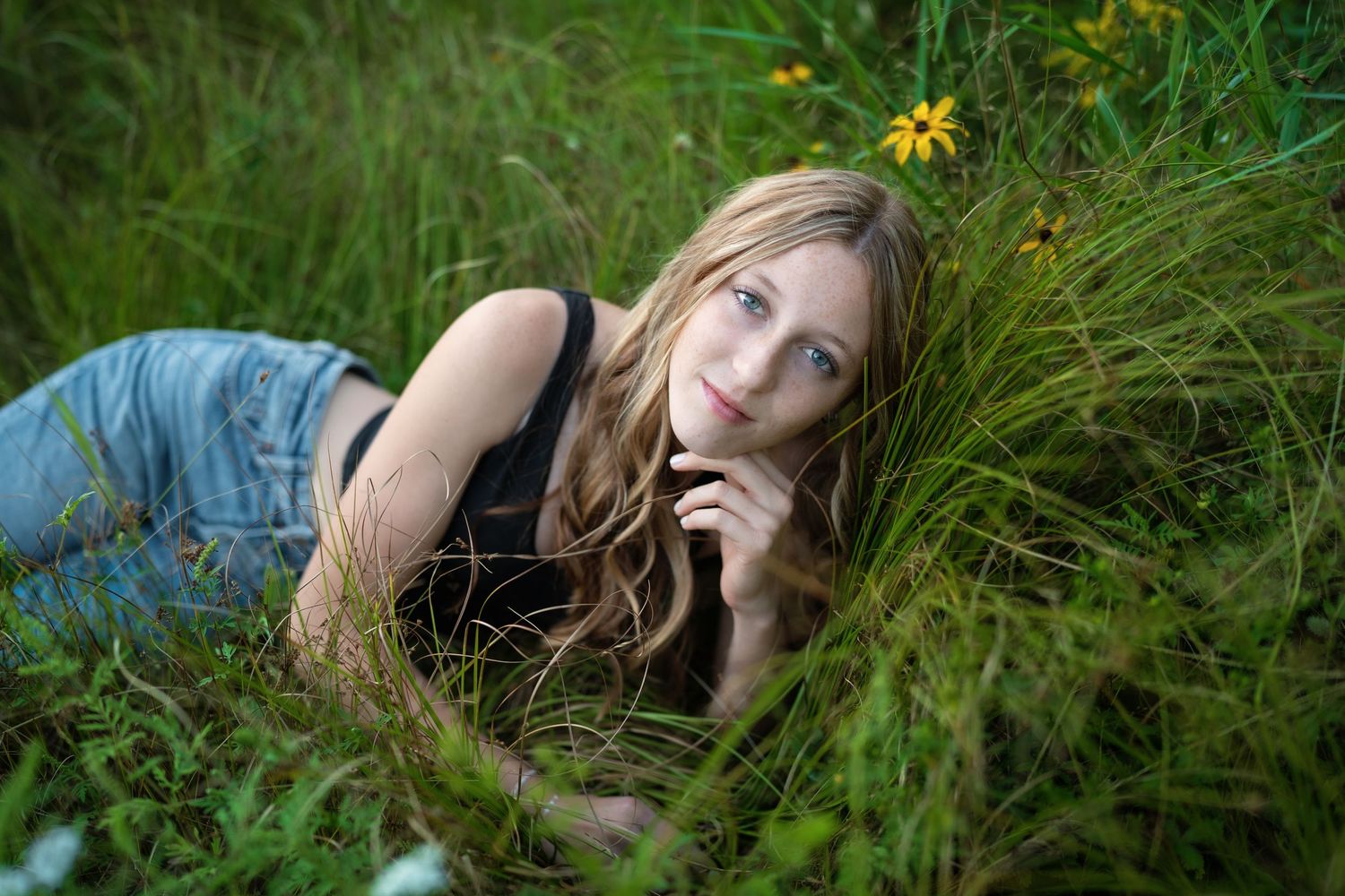 A series of portraits in a grassy meadow with yellow wildflowers at sunset.