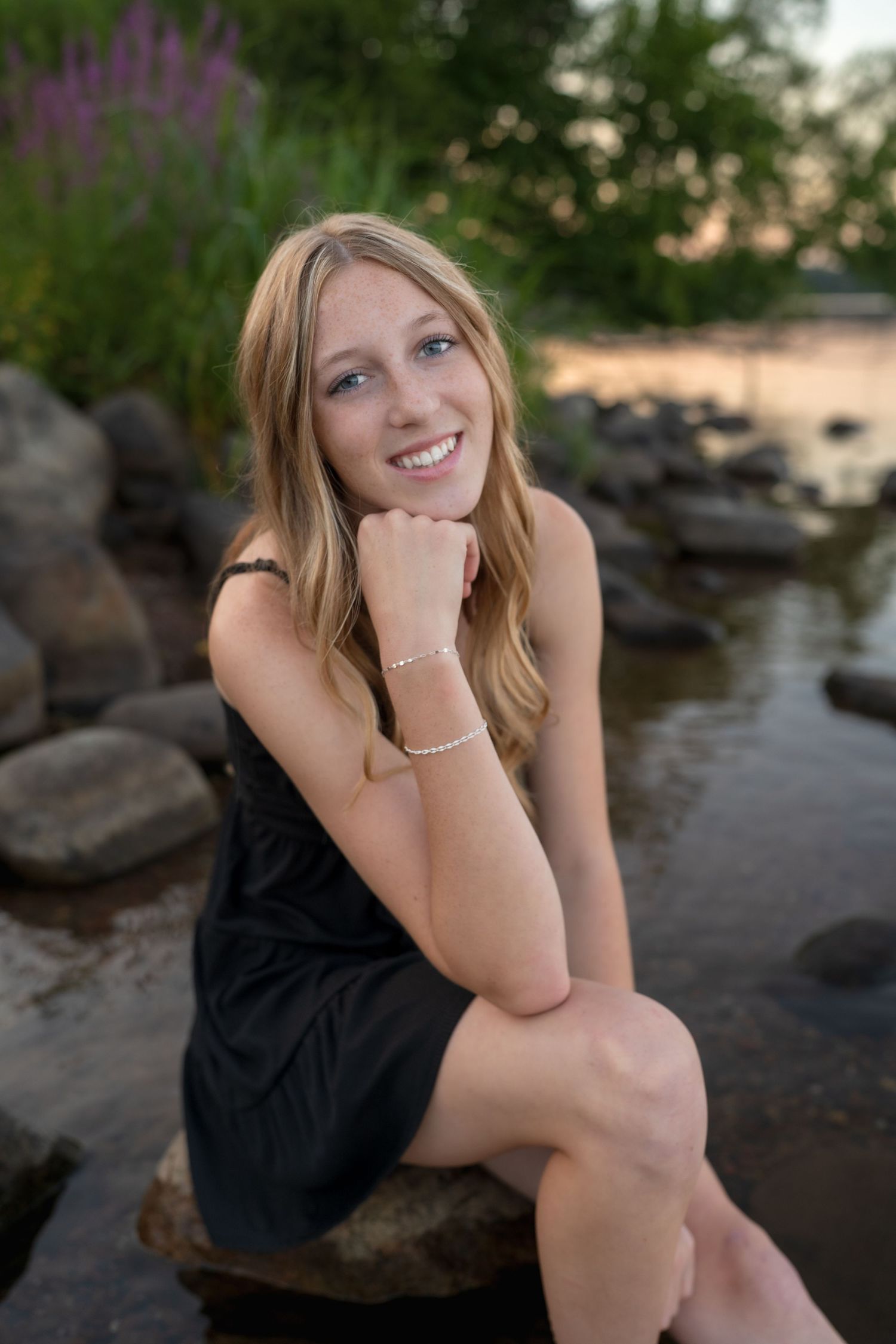 Artistic portrait composition with rocks and water during a lakeside sunset session.