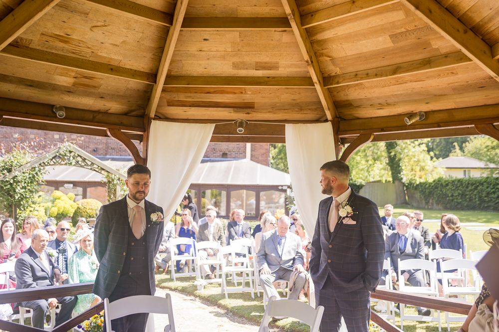 Interior view of a wooden gazebo decorated for a wedding ceremony.