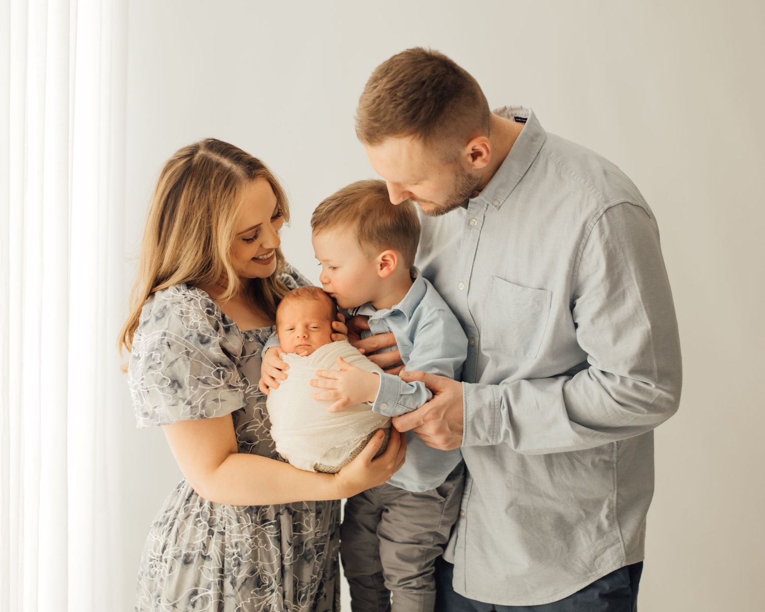 Mother and father with their newborn during a posed studio session in Oklahoma