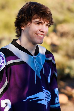 A person wearing a purple and blue sports jersey smiles while looking to the side in a series of cropped photos.
