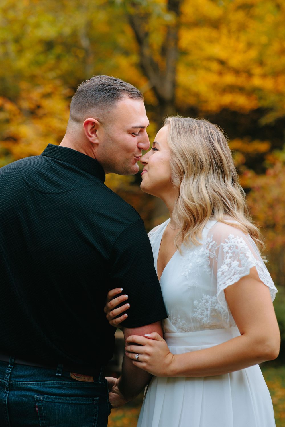 A romantic sequence of wedding photos showing a couple embracing against a backdrop of vibrant autumn foliage.