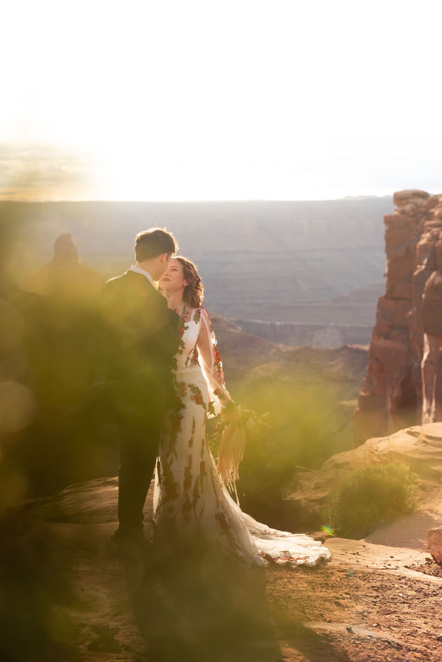 Desert wedding photography with golden sunlight and canyon views.