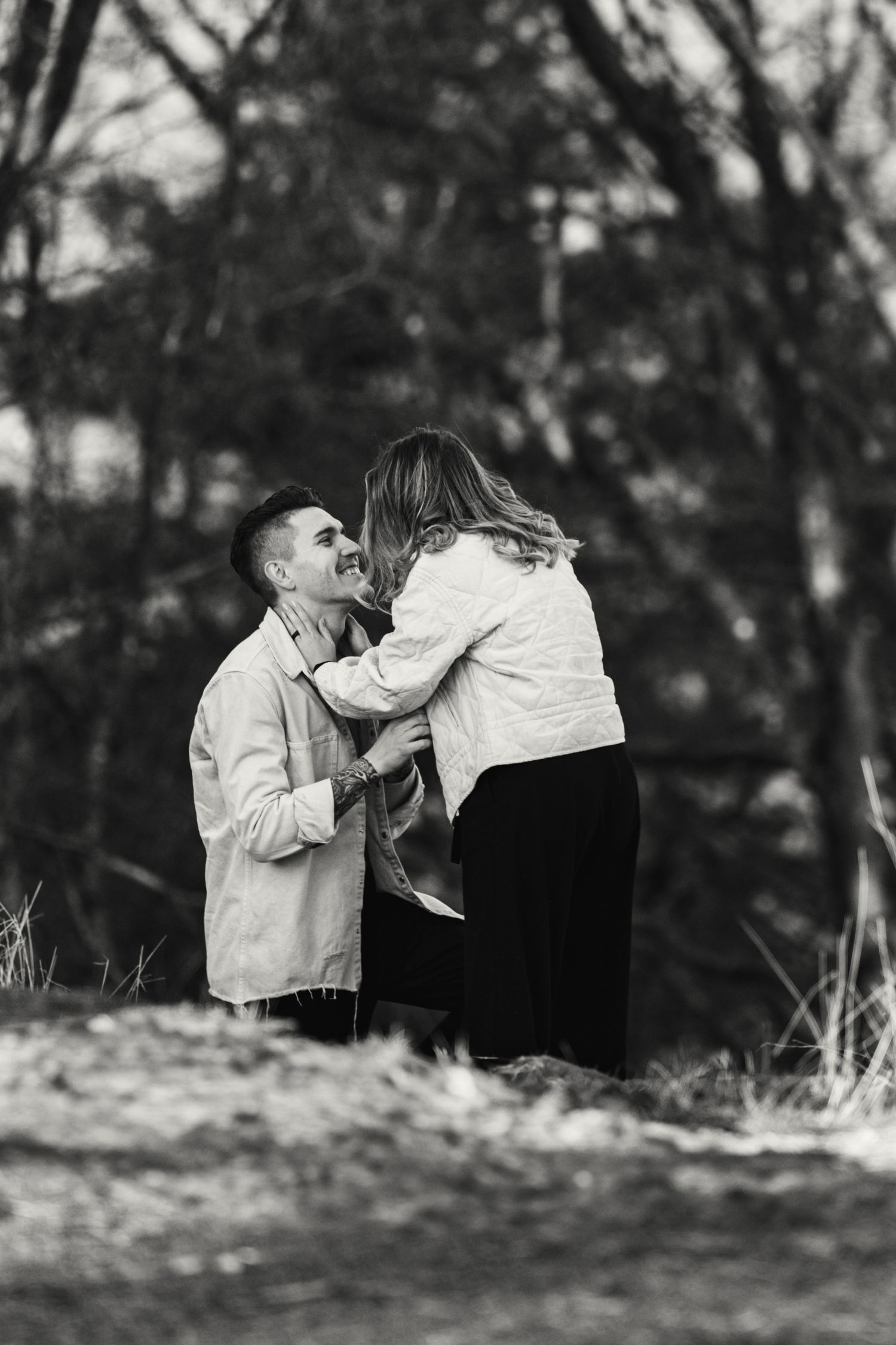 A black and white photo sequence shows a couple sharing a romantic kiss outdoors in a natural setting.