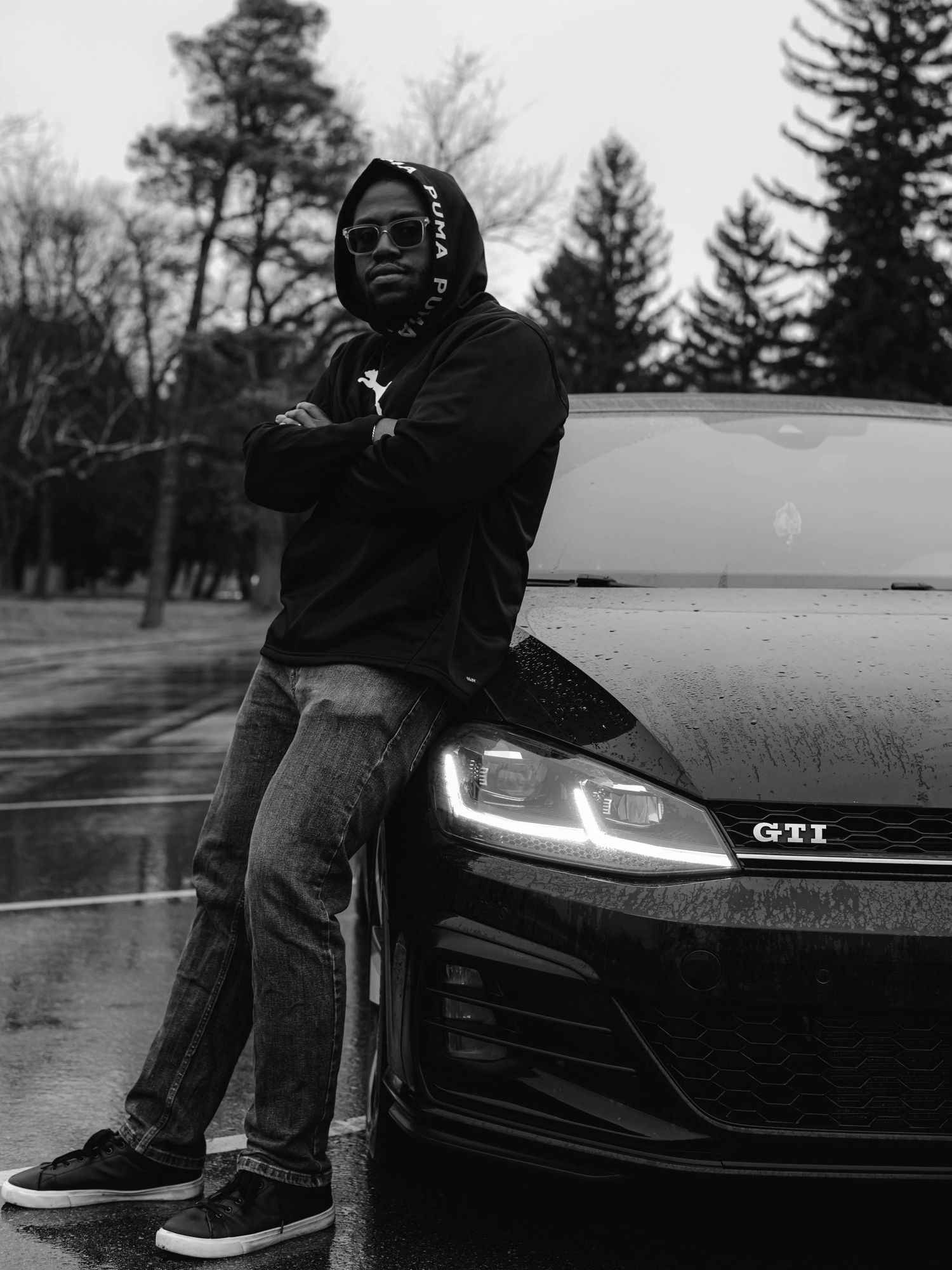 Black and white photos featuring a GTI car with dramatic lighting and stylized poses.