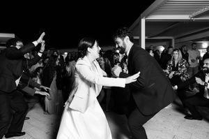 A series of black and white candid photos showing joyful moments at a wedding reception.
