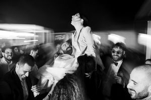 A black and white photo montage shows people dancing and celebrating at what appears to be a nightclub or party.