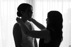 Silhouetted figures in intimate poses against a bright white background create a romantic and artistic composition.