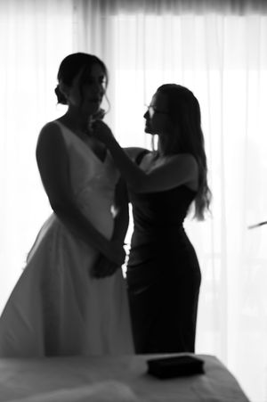 Black and white silhouettes of dancing couples in formal attire against a white background.