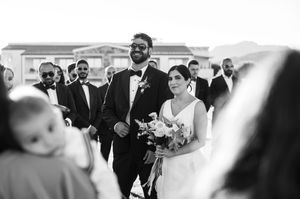 Black and white photo series showing joyful wedding moments with guests and loved ones celebrating together at a ceremony.