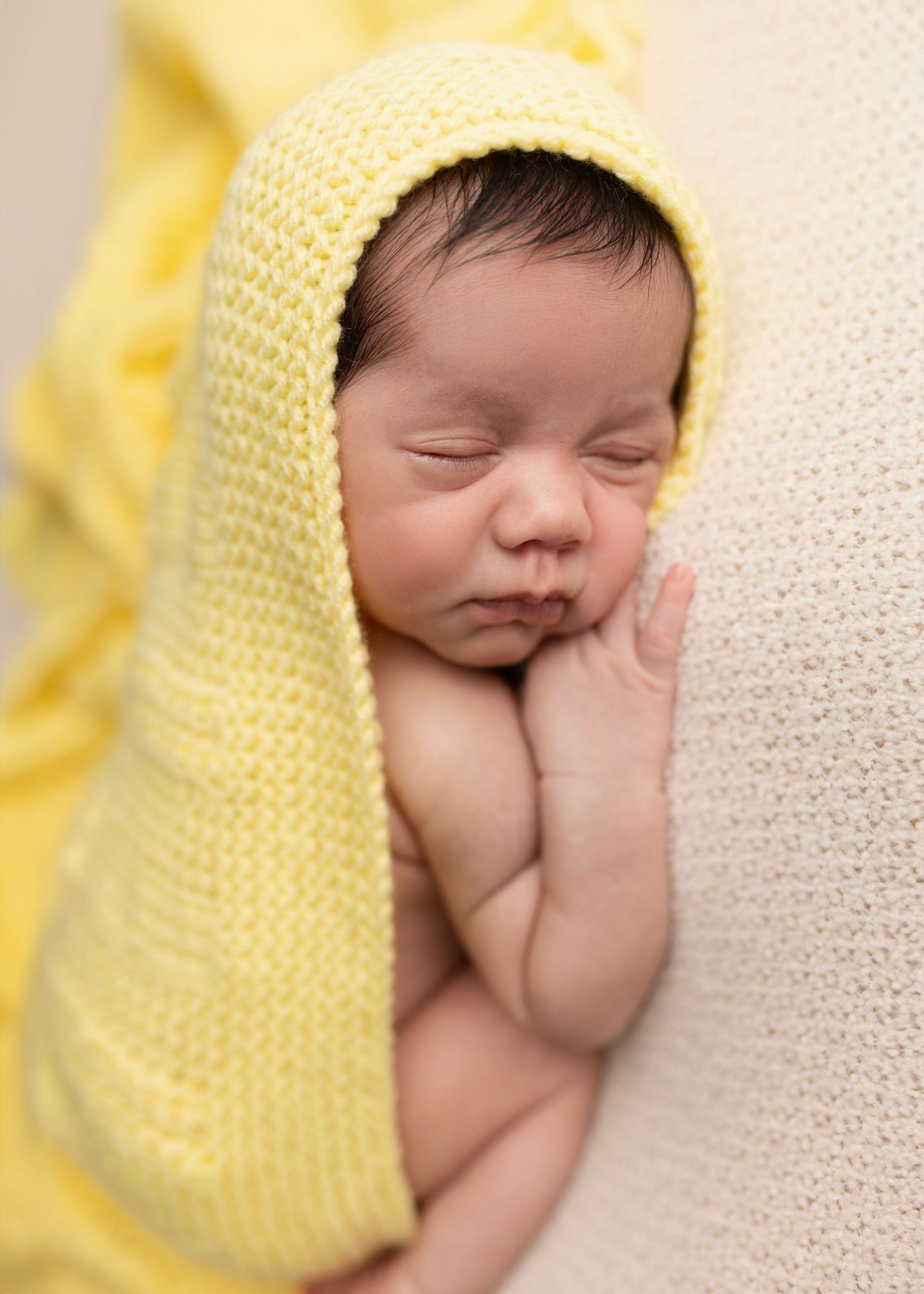 Newborn baby boy poses for newborn photos studio Elizabeth Lang Photography Surrey Cloverdale. Wrapped in a special yellow blanket