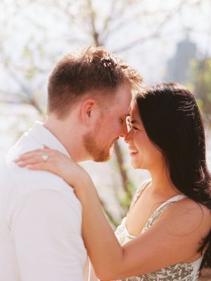 A romantic couple embraces outdoors in soft sunlight, shown in an intimate wedding photography sequence.