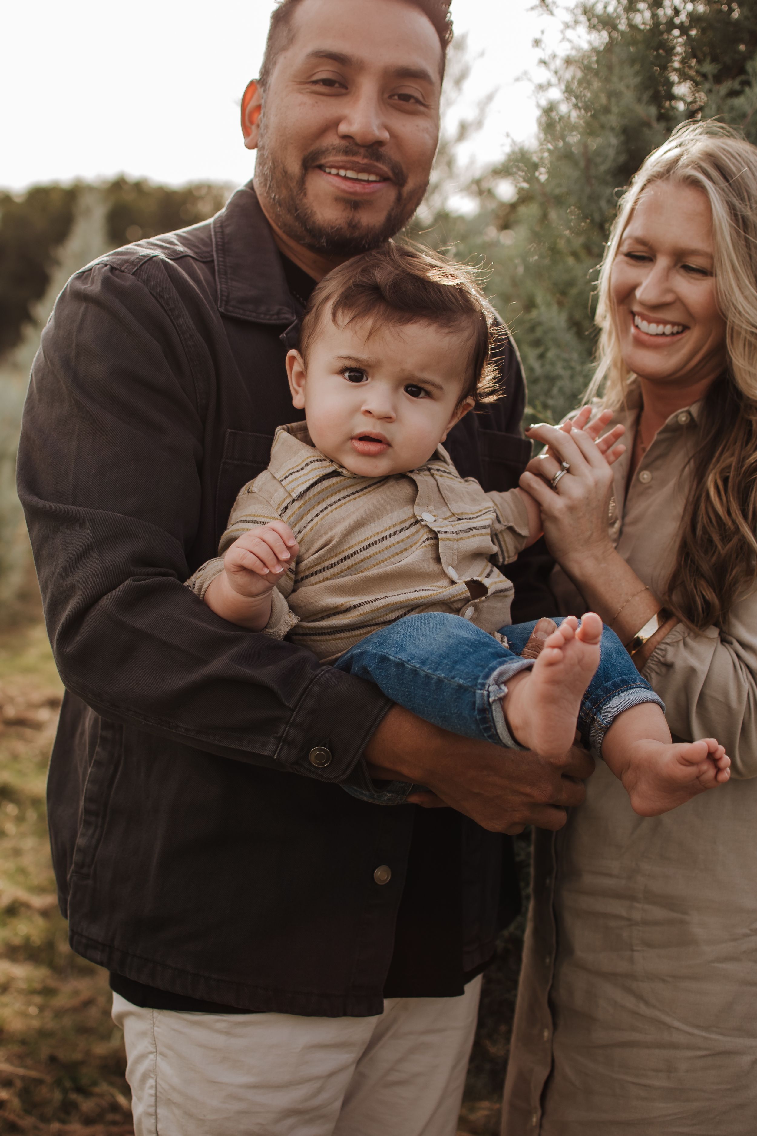 Candid family moments captured in warm tones during an outdoor photo session.