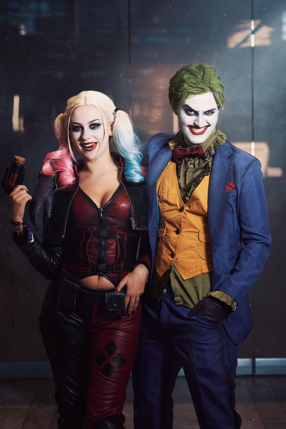 Cosplayers dressed as comic book villains pose together in dramatic lighting.