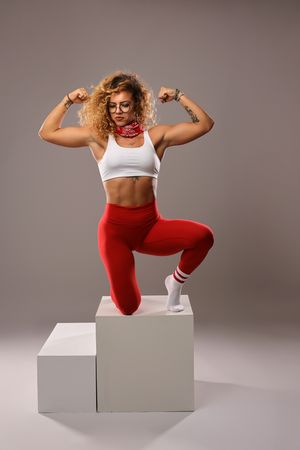 Athletic movements demonstrated on white blocks showing power and control in red and white attire.