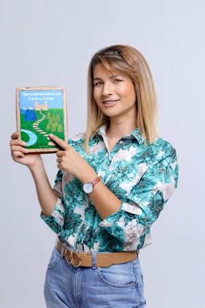 A photo composition of someone wearing a floral turquoise blouse and jeans holding up a children's board book.