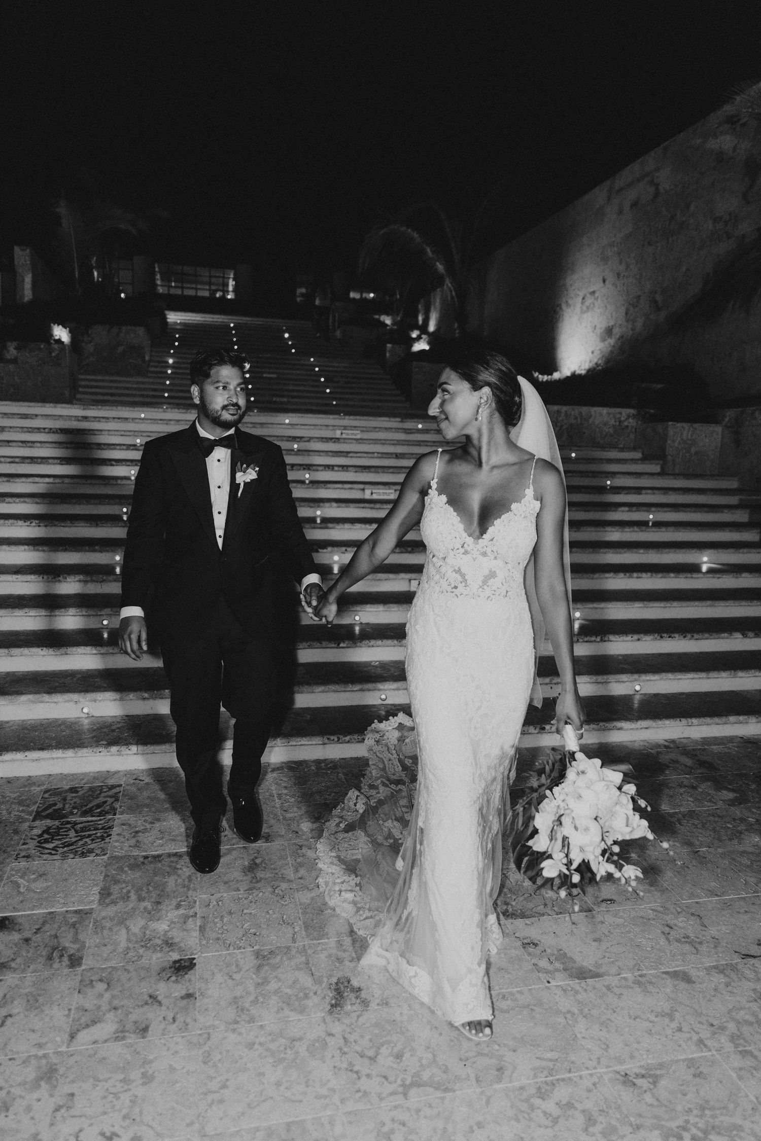 A black and white wedding photo sequence shows a couple walking down stone steps.