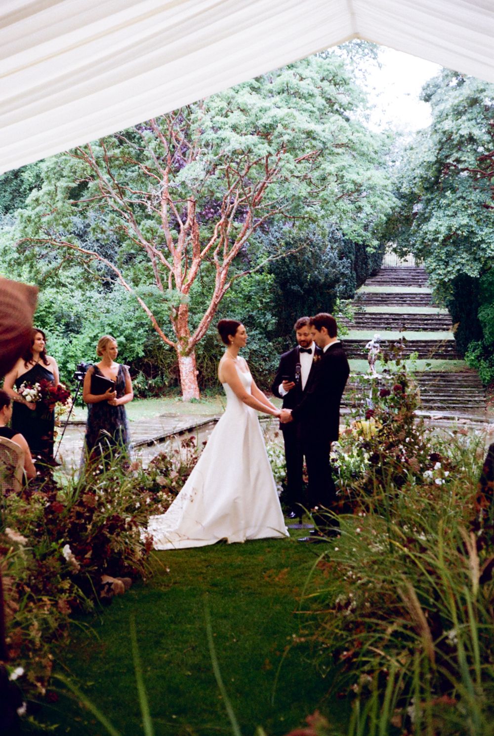 Bride & groom during vows with officiant in view