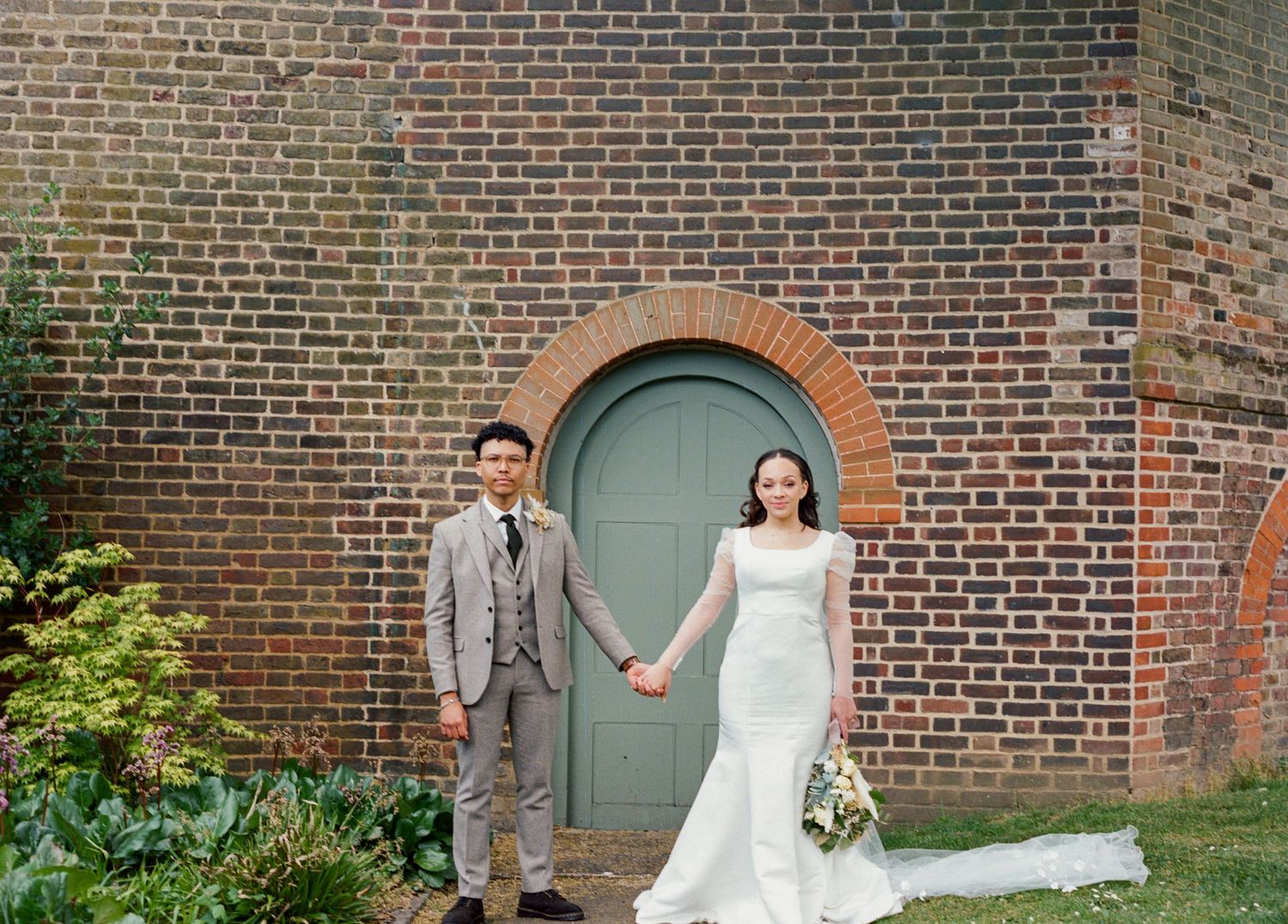 Portrait of Bride & groom holding hands