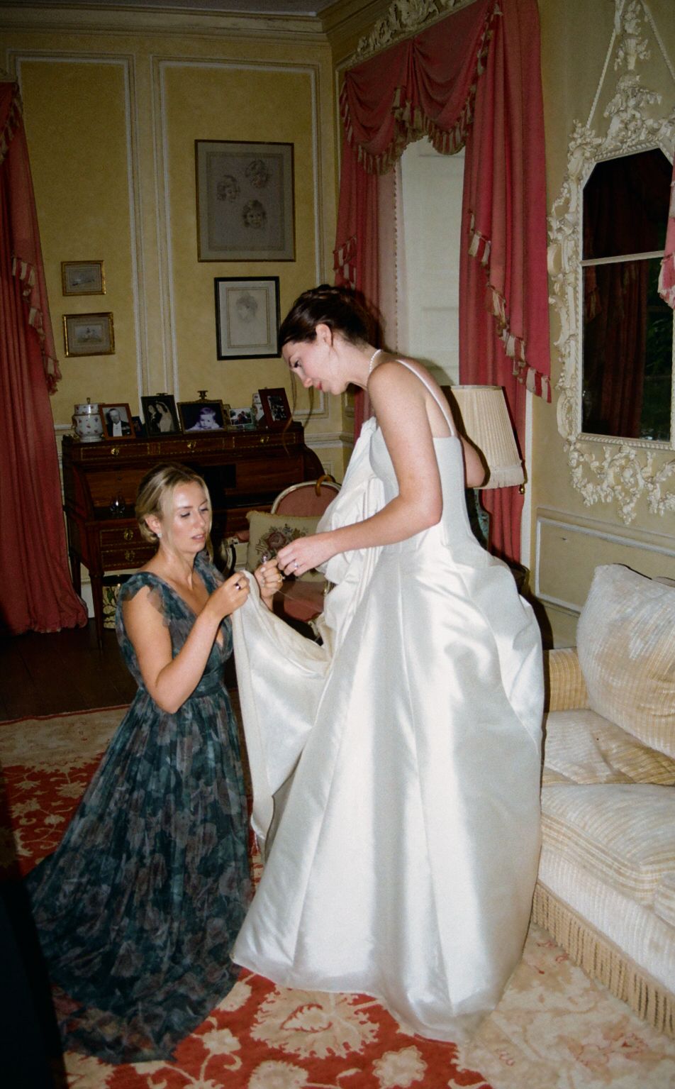 bride and bridesmaid adjusting dress, behind‑the‑scenes moment
