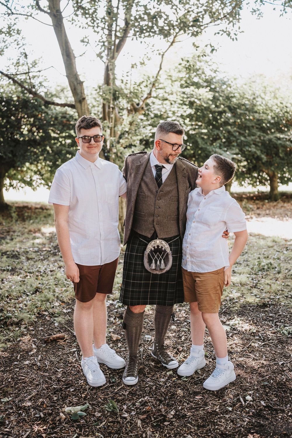 Three vintage-inspired casual outfits captured in outdoor forest setting featuring brown and white clothing combinations.