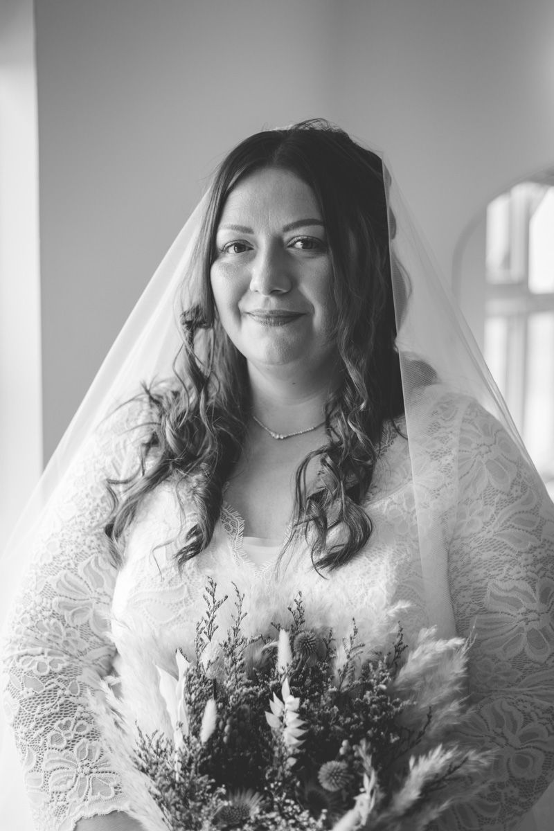 A bride in a white lace wedding dress poses in a series of close-up portraits with delicate floral details.