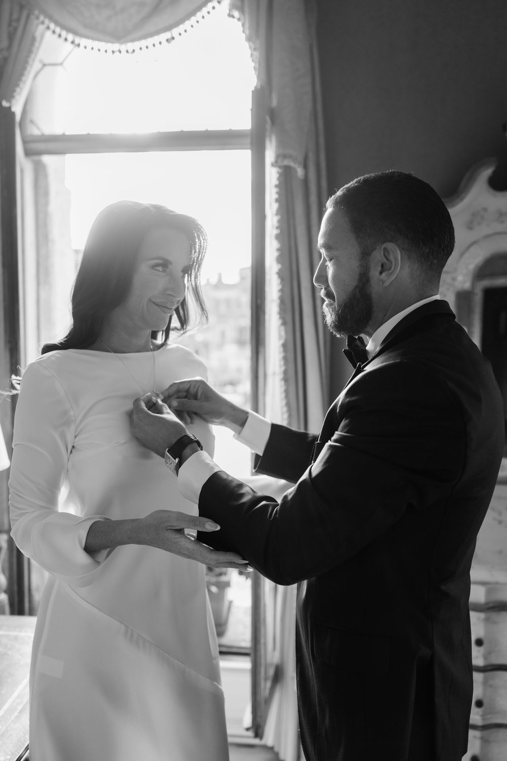 A series of black and white photos showing a couple in formal wedding attire sharing a tender dance moment together. Venice Photographer