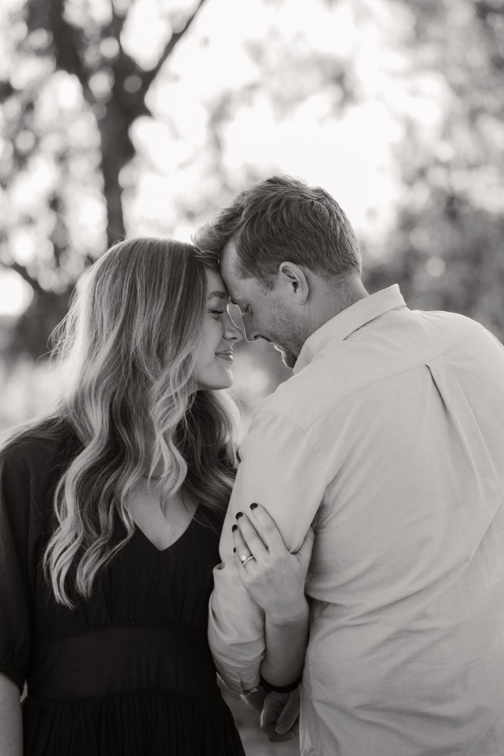 Black and white intimate family photos showing tender moments outdoors.