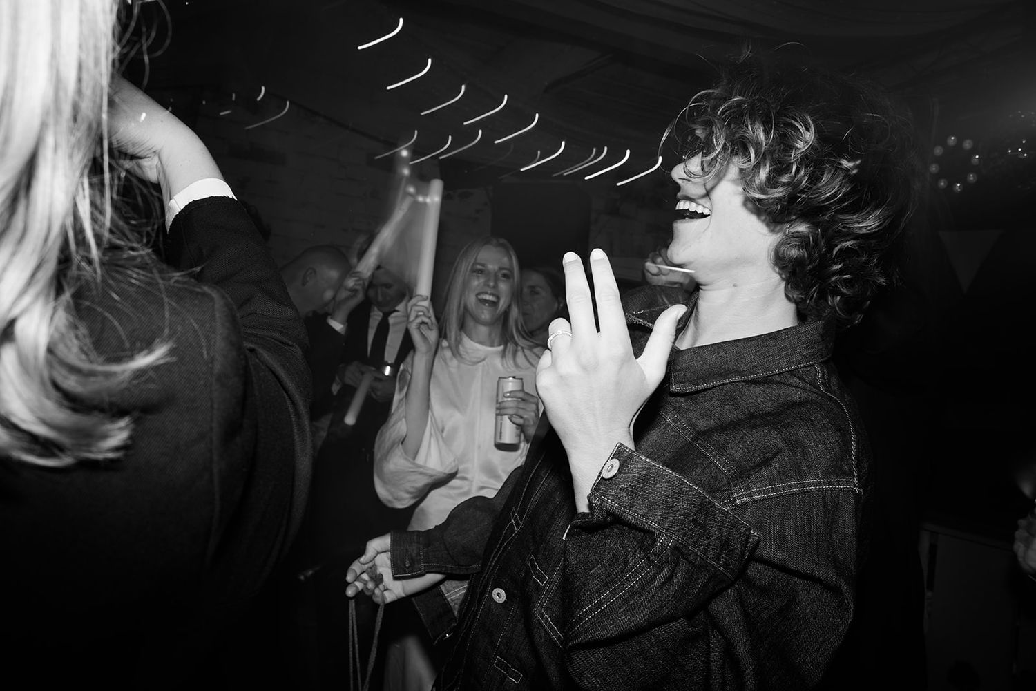 A black and white photo collage showing multiple people drinking from bottles in a nightclub setting.