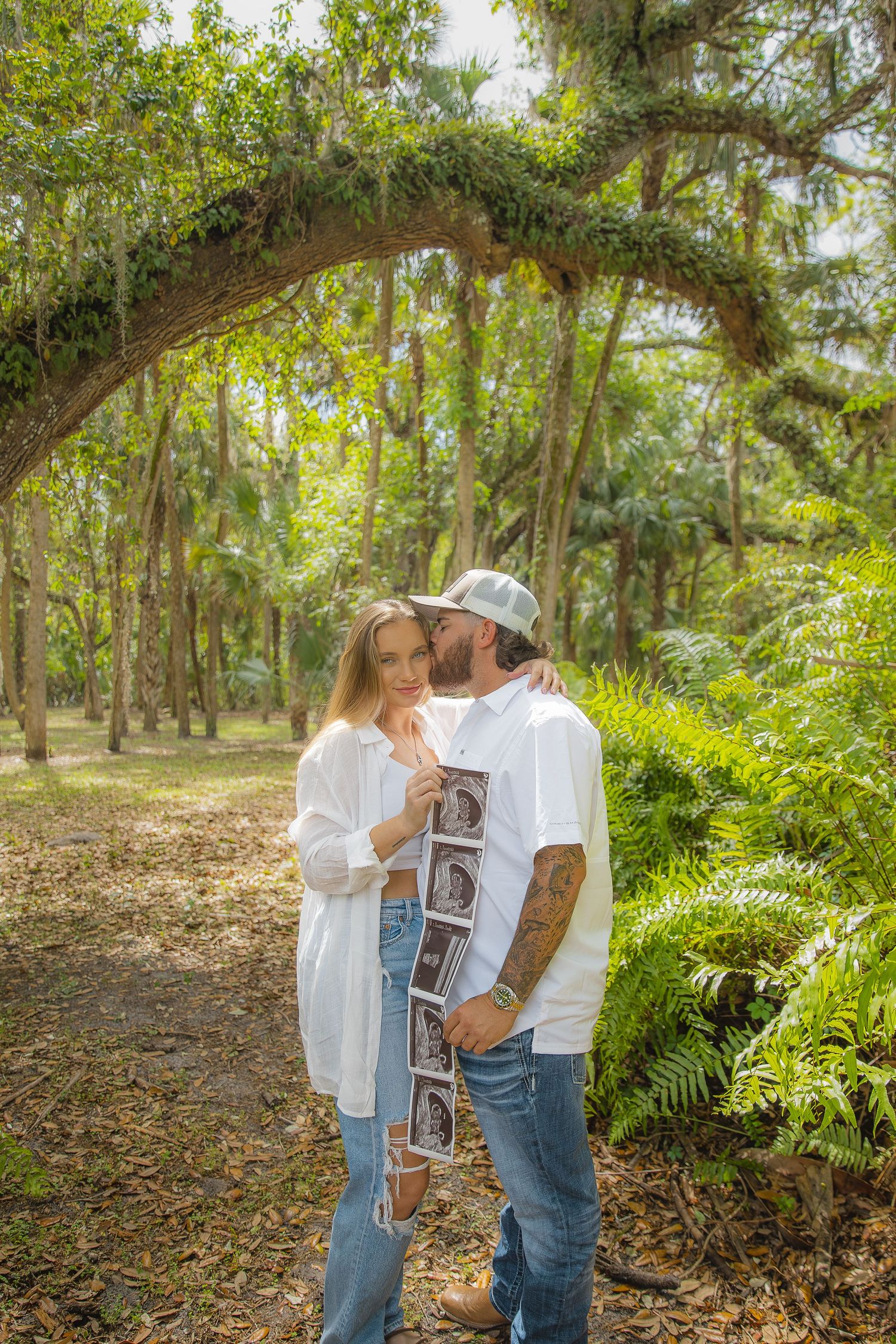 Candid Fort Myers maternity photography of Eric and Taylor celebrating parenthood with soft, natural light and warm tones.