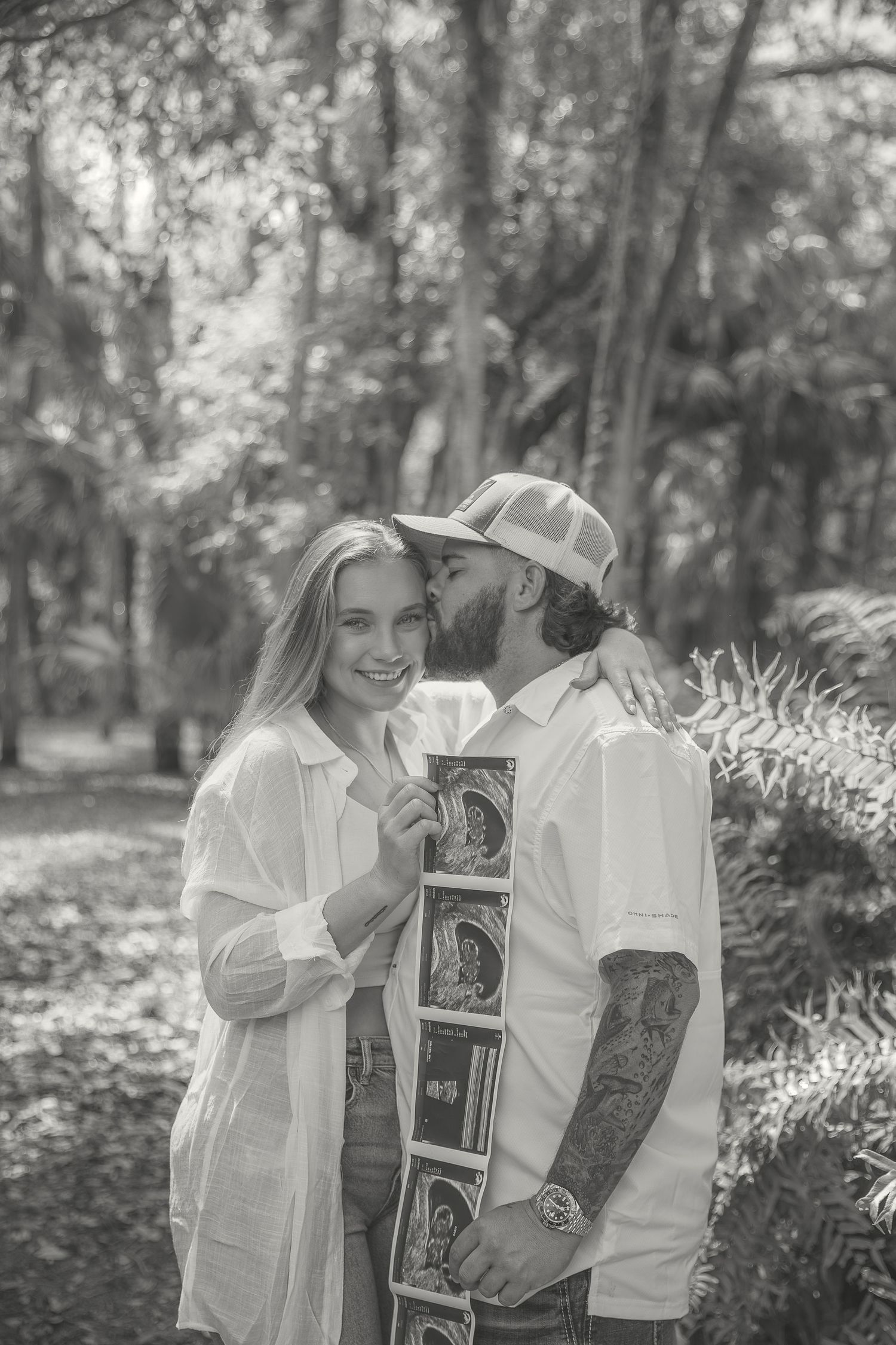 Candid Fort Myers maternity photography of Eric and Taylor celebrating parenthood with soft, natural light and warm tones.