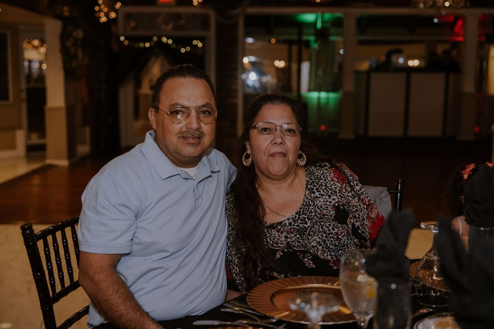 Couple enjoying a formal dinner event at an elegantly decorated venue.