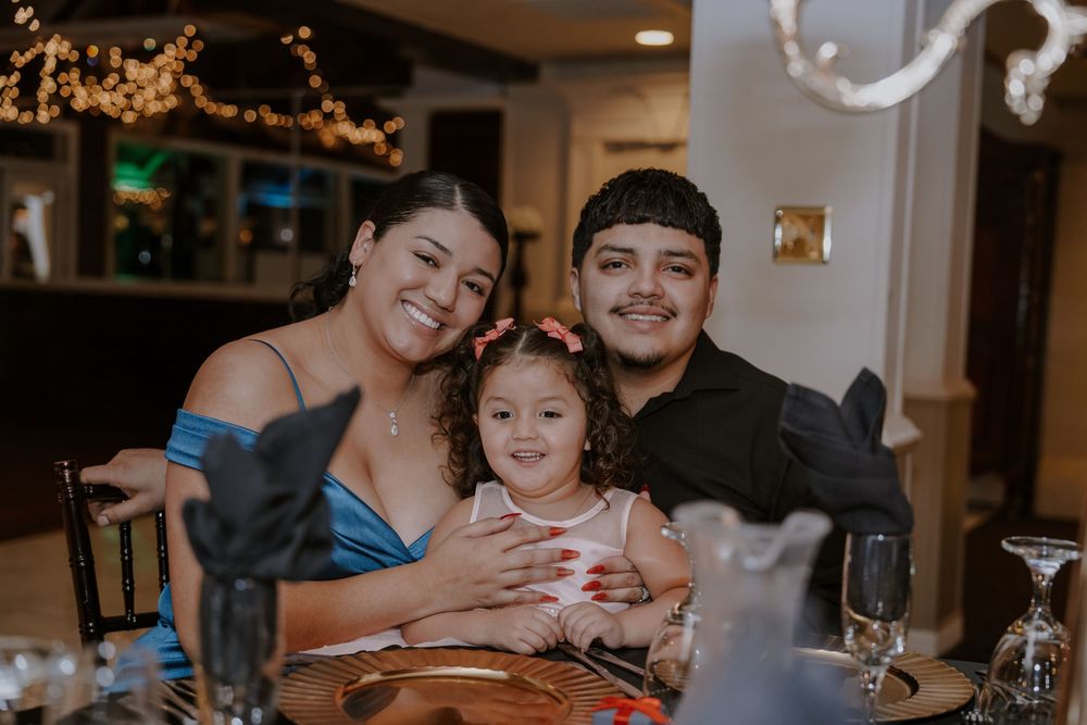 Family sharing a joyful moment together at a formal dinner celebration.