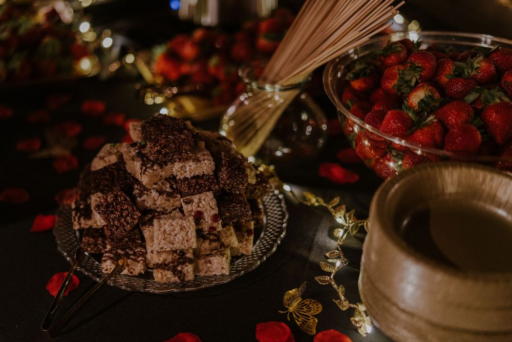 Dark chocolate dessert with fresh strawberries and wine on an elegant table setting.