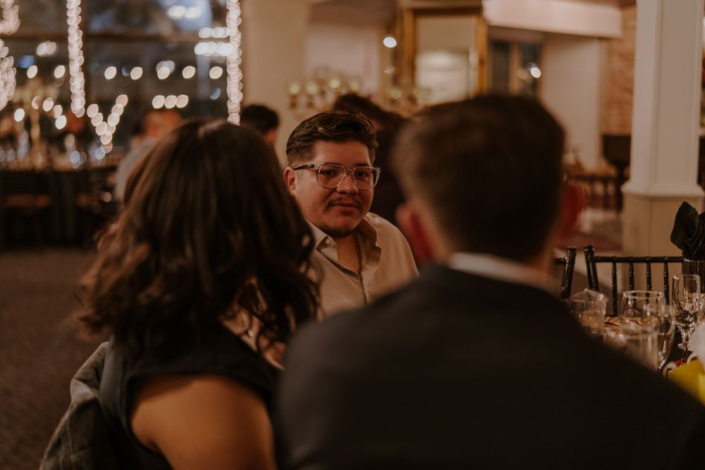 Warm evening gathering at a restaurant with ambient lighting and intimate conversation.