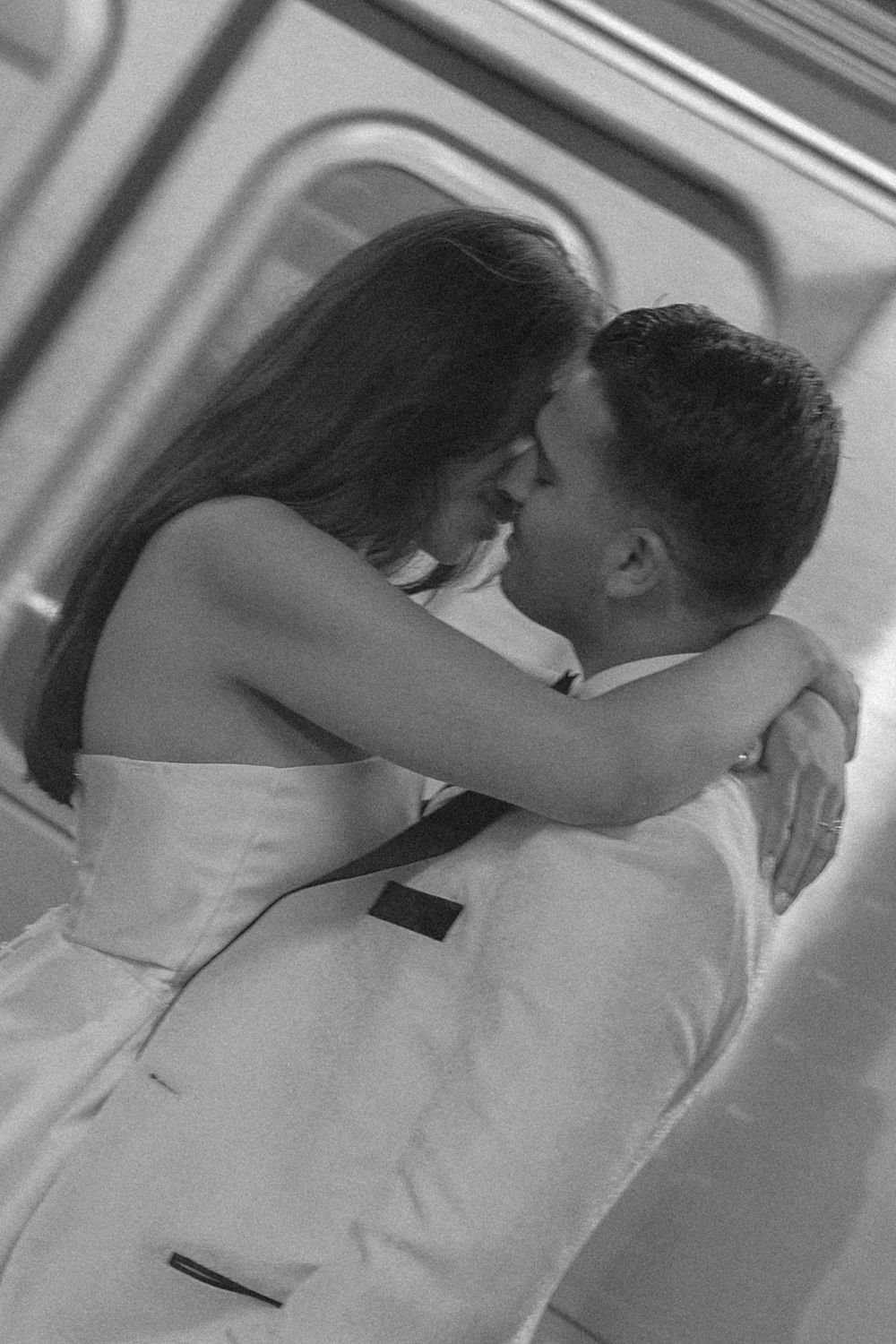 A black and white sequence of photographs showing a romantic kiss between two people in formal attire.