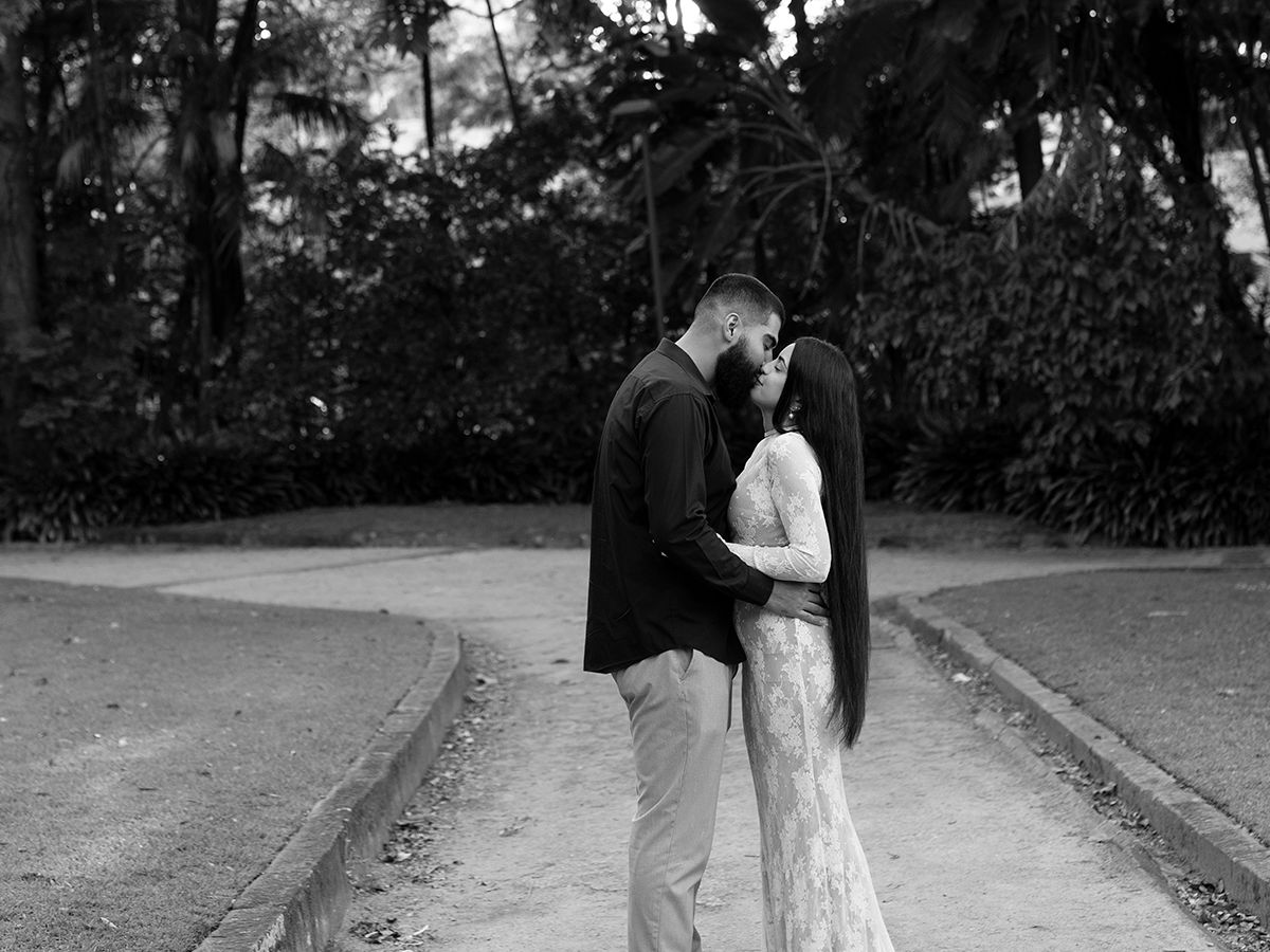 A series of black and white photographs showing people walking on a path through a garden or park setting.