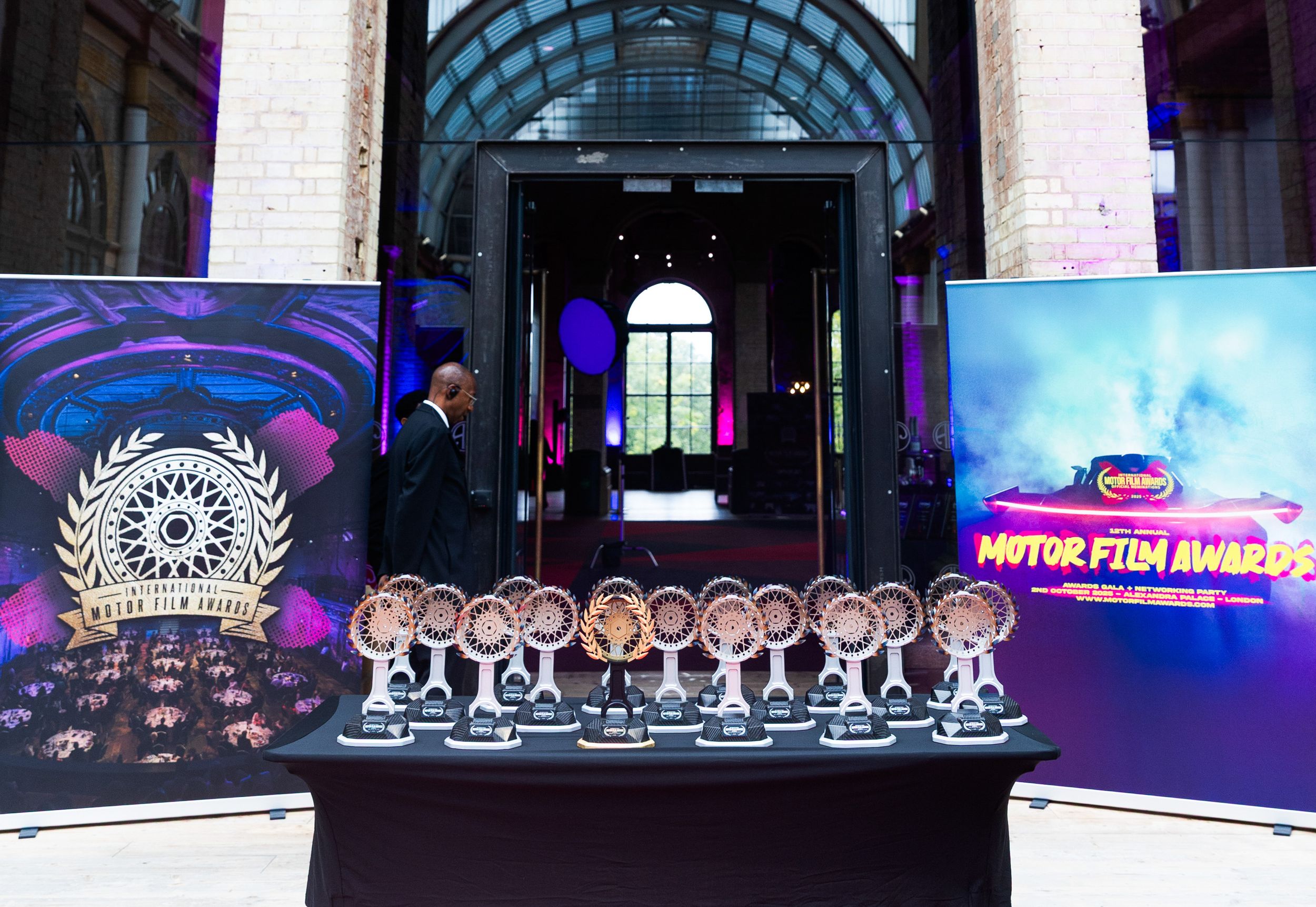 Awards ceremony display with cartoon cutouts and banners in front of an arched entrance.