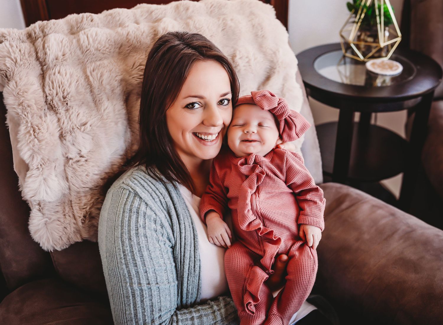 A cozy scene of a parent and child sharing joyful moments on a comfortable couch at home.