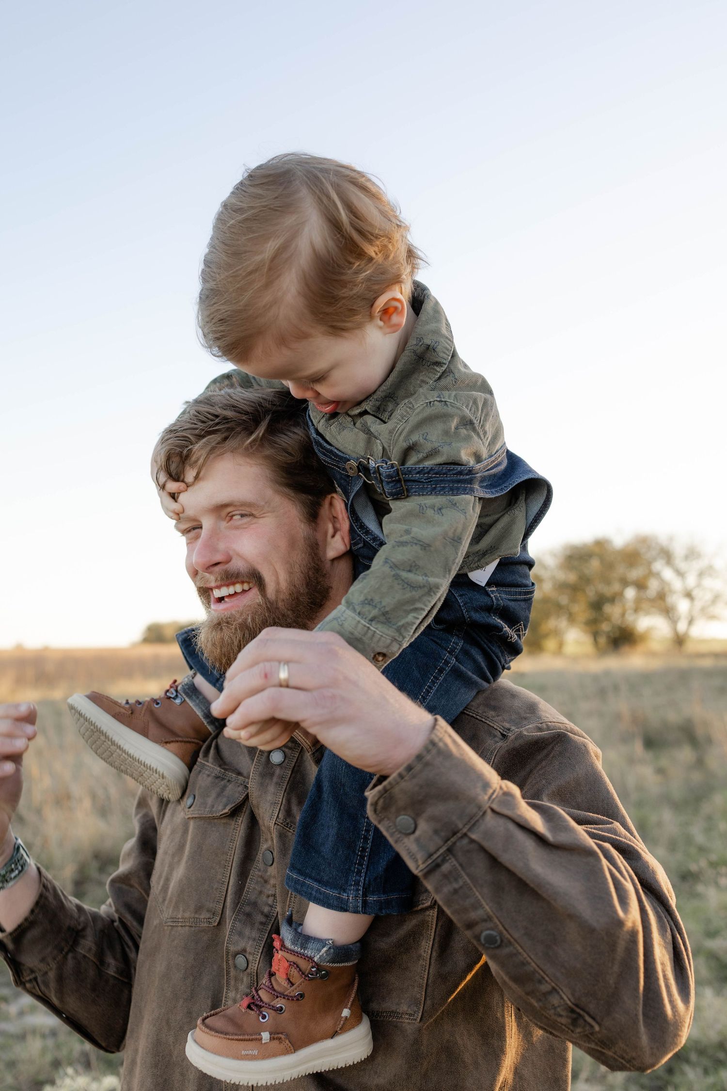 True West Photography - Playful parent-child interaction outdoors during golden hour.