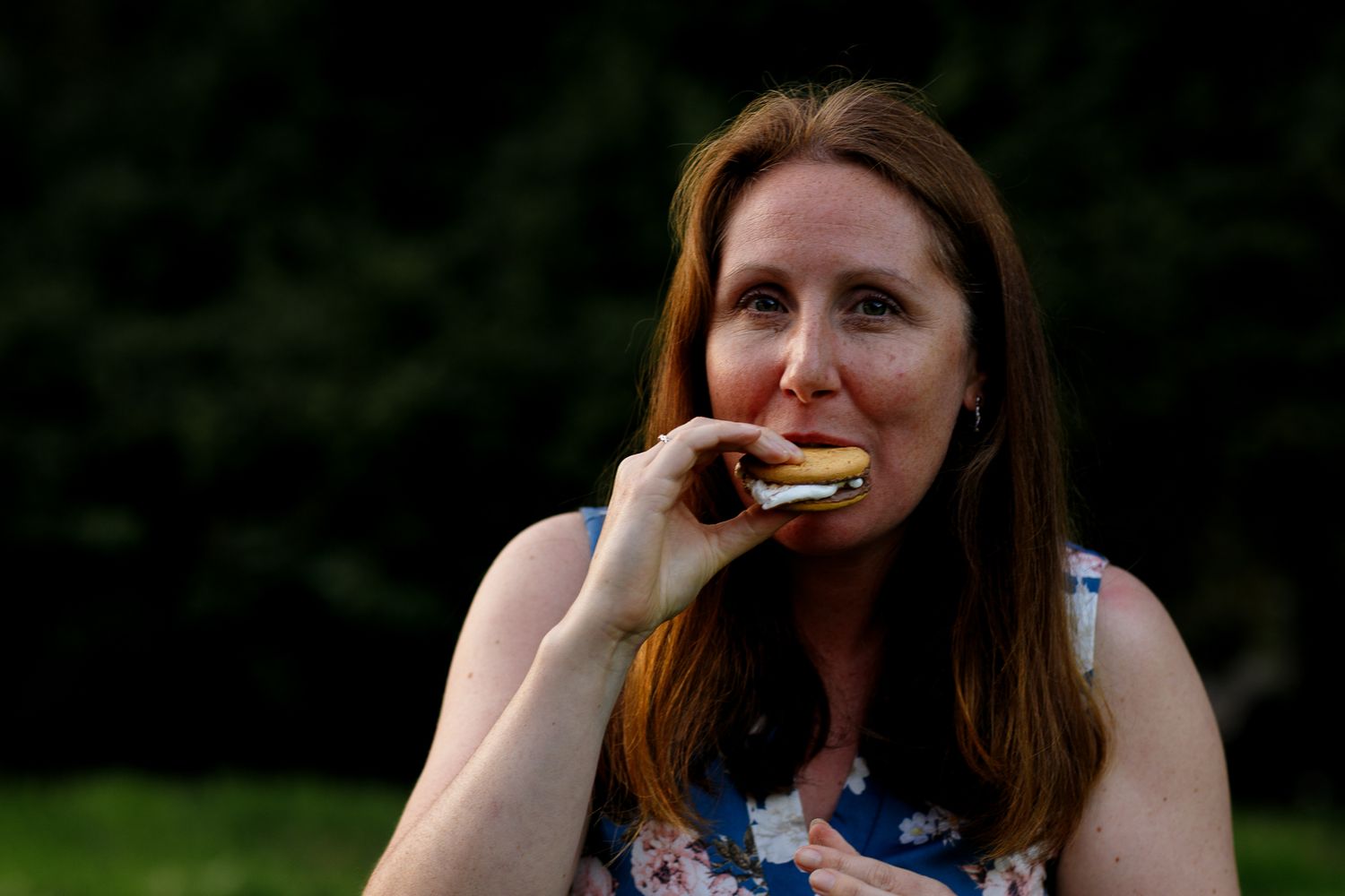 A sequence of seven similar photos showing someone enjoying a snack outdoors with trees in the background.