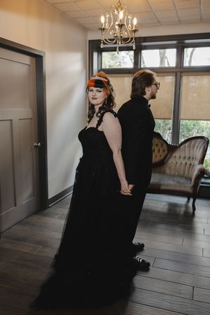 A sequence of romantic photos showing two people in black dresses dancing in an elegant room with a chandelier.