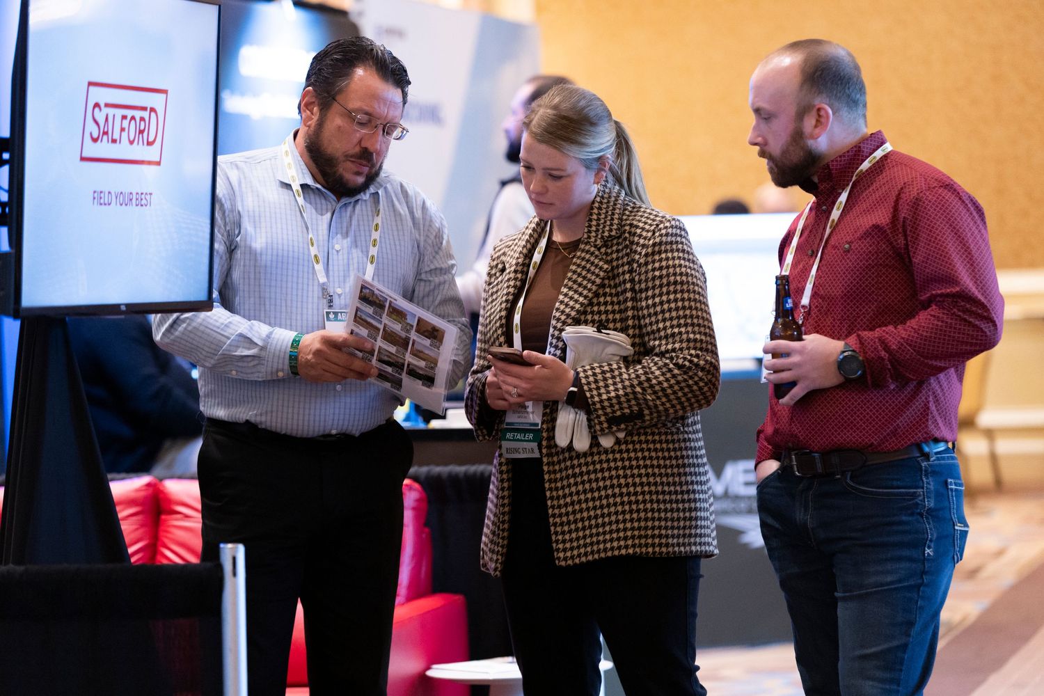 People gather around a table examining documents at the expo at the grand america hotel salt lake city; utah event photographer conference