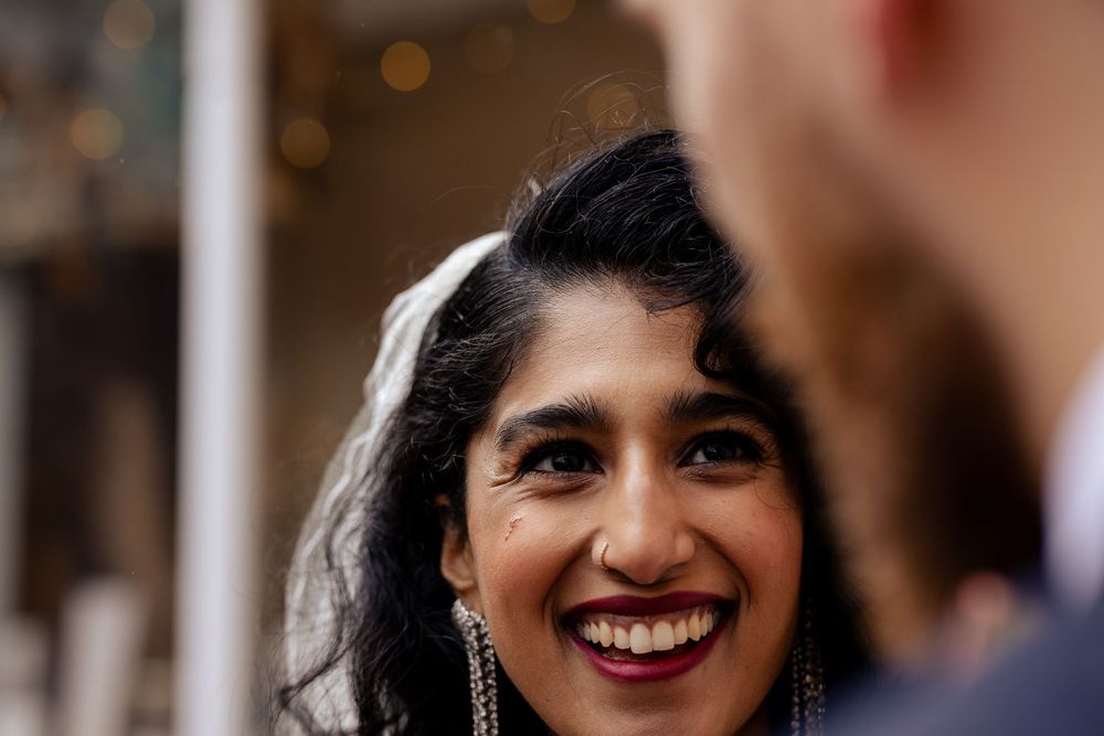 Candid wedding portrait showing genuine laughter and happiness.